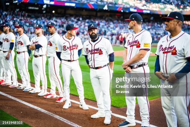 Raisel Iglesias, Jarred Kelenic, Luis Guillorme, Sean Murphy and Eddie Perez of the Atlanta Braves stand during introductions before the game against...