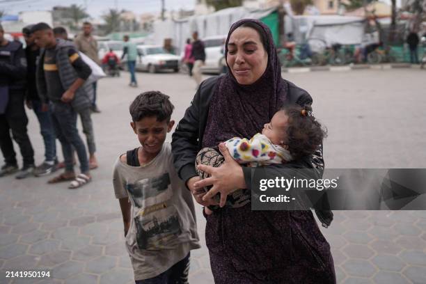 Palestinians react at a hospital where casualties of Israeli bombardment on al-Bureij camp in the central Gaza Strip were transported on April 8 as...