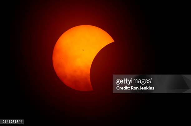 The moon begins to eclipse the sun on April 8, 2024 in Fort Worth, Texas. Millions of people have flocked to areas across North America that are in...