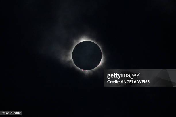 The moon eclipses the sun during a total solar eclipse across North America, at Niagara Falls State Park in Niagara Falls, New York, on April 8,...
