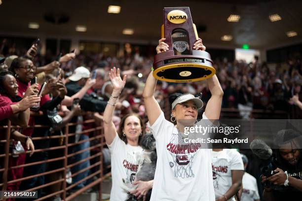 South Carolina coach Dawn Staley raises the NCAA Women's Basketball Championship trophy at a celebration at the Colonial Life Arena on April 8, 2024...