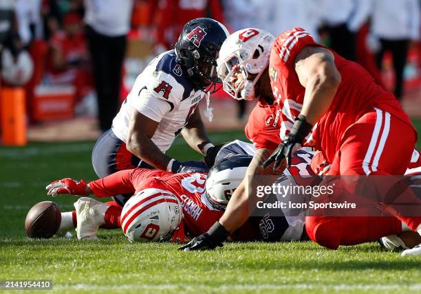 Defenders defensive linemen Trent Harris and Niles Scott fight Houston Roughnecks running back T.J. Pledger IV and center Jack Kramer for possession...