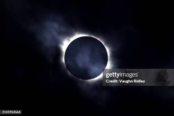 Solar eclipse is seen through the clouds on April 8, 2024 in Niagara Falls, Ontario, Canada. Millions of people have flocked to areas across North...