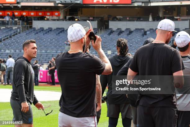 Miami Marlins players come out on the field to view the Solar Eclipse with special Eclipse glasses at Yankee Stadium prior to the game between the...