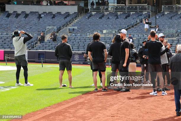 Miami Marlins players come out on the field to view the Solar Eclipse with special Eclipse glasses at Yankee Stadium prior to the game between the...