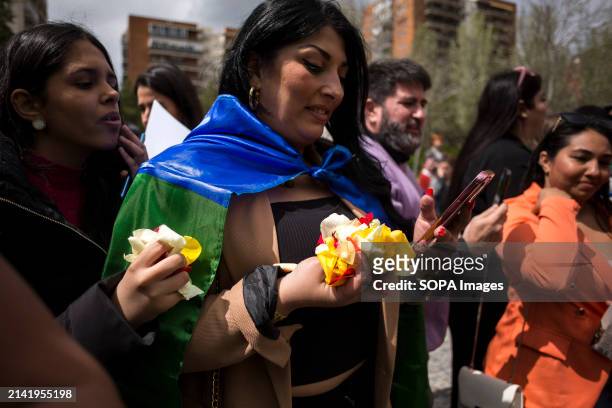Woman holds rose petals in her hands to throw them into the river, during the institutional event to celebrate the International Day of the Gypsy...