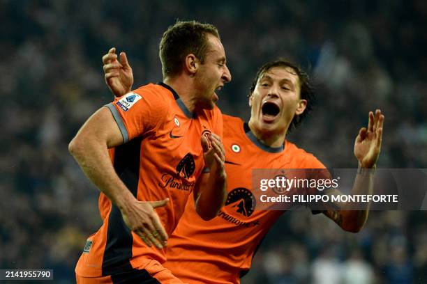 Inter Milan's Italian midfielder Davide Frattesi is congratulated by Inter Milan's Italian midfielder Nicolo Barella after scoring a goal during the...