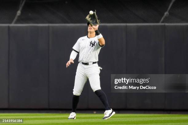 Aaron Judge of the New York Yankees catches a fly ball during the game between the Miami Marlins and the New York Yankees at Yankee Stadium on...