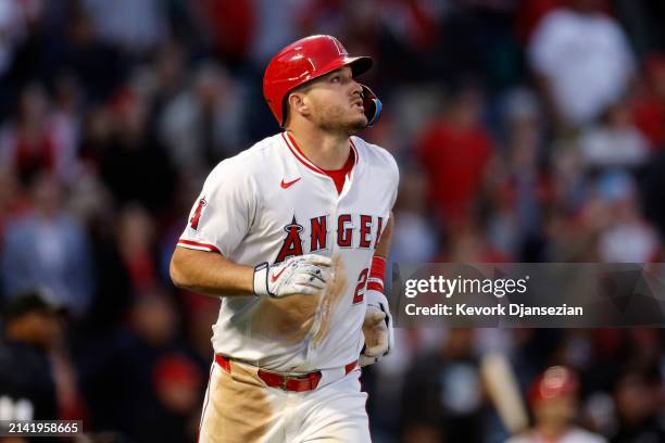 Mike Trout of the Los Angeles Angels looks at his one run home run against pitcher Zach Eflin of the Tampa Bay Rays during the third inning at Angel...