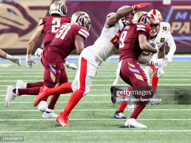 Michigan Panthers wide receiver Marcus Simms gets tackled by Birmingham Stallions running back Ricky Person Jr. During the UFL football game between...