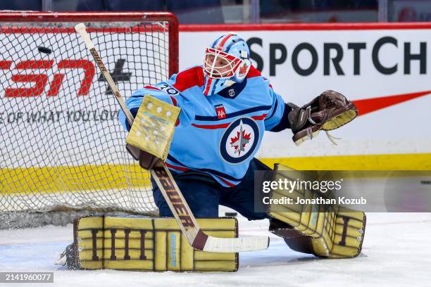 Goaltender Laurent Brossoit of the Winnipeg Jets takes part in the pre-game warm up prior to NHL action against the Los Angeles Kings at Canada Life...