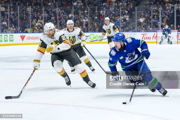 Shea Theodore of the Vegas Golden Knights defends against Conor Garland of the Vancouver Canucks during the third period of their NHL game at Rogers...
