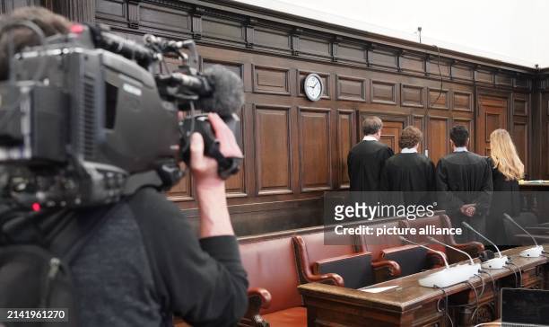 April 2024, Hamburg: Lawyers stand in front of the accused women in the courtroom at the Criminal Justice Building at the start of the trial against...