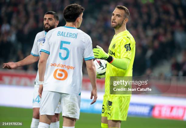 Marseille goalkeeper Pau Lopez talks to Leonardo Balerdi, left Samuel Gigot of Marseille during the Ligue 1 Uber Eats match between Lille OSC and...