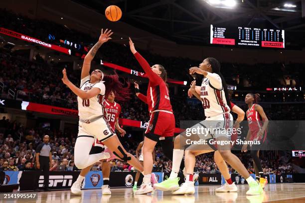 Kamilla Cardoso of the South Carolina Gamecocks shoots the ball in front of River Baldwin of the NC State Wolfpack as Sania Feagin of the South...