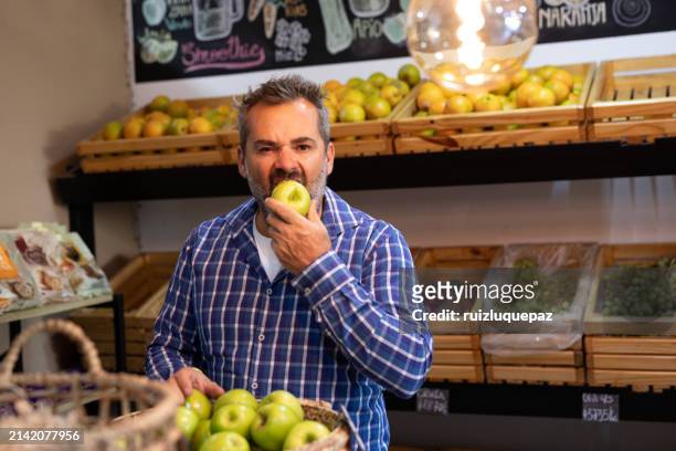 mature man shopping in a greengrocer - apple products stock pictures, royalty-free photos & images
