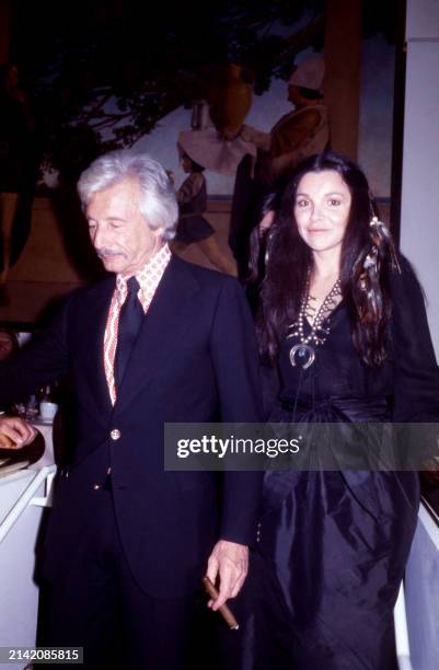 American fashion designer Oleg Cassini walks with his wife Marianne Nestor at the Manhattan nightclub and disco Studio 54 in New York, New York,...