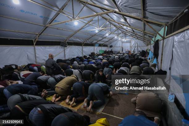 Palestinian Muslims celebrate Laylat al-Qadr on the ruins of the Al-Farouq Mosque on April 06, 2024 in Rafah, Gaza. Al-Farouq Mosque had been...