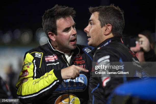 Timmy Hill, driver of the Coble Enterprises/UNITS Toyota, and Stewart Friesen, driver of the Aim Autism/Halmar Toyota, have a heated conversation on...