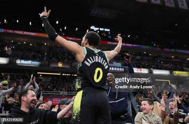 Tyrese Haliburton of the Indiana Pacers celebrates after making a three point shot against the Oklahoma City Thunder at the end of the third quarter...