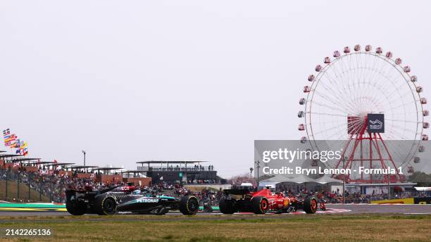 Charles Leclerc of Monaco driving the Ferrari SF-24 leads George Russell of Great Britain driving the Mercedes AMG Petronas F1 Team W15 during final...