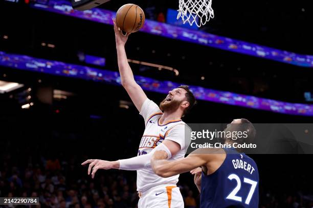 Jusuf Nurkic of the Phoenix Suns attempts a layup against Rudy Gobert of the Minnesota Timberwolves during the first half at Footprint Center on...