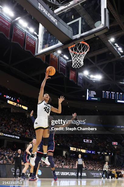 Hannah Stuelke of the Iowa Hawkeyes shoots the ball over Aaliyah Edwards of the UConn Huskies in the first half during the NCAA Women's Basketball...