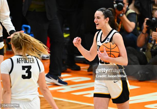 Caitlin Clark of the Iowa Hawkeyes reacts after beating the UConn Huskies during the NCAA Women's Basketball Tournament Final Four semifinal game at...