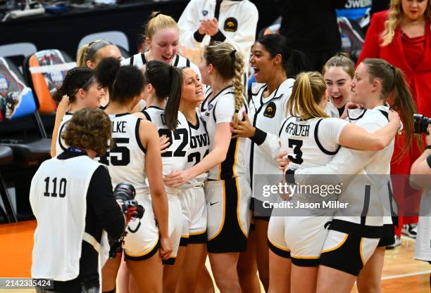 The Iowa Hawkeyes celebrate after beating the UConn Huskies in the NCAA Women's Basketball Tournament Final Four semifinal game at Rocket Mortgage...