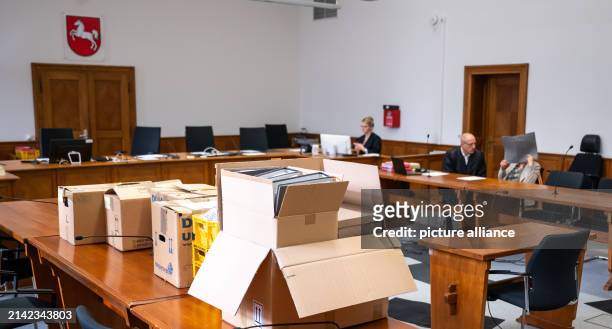 April 2024, Lower Saxony, Lüneburg: The defendant sits in the district court next to her defense lawyer Norbert Lösing , while boxes of documents...