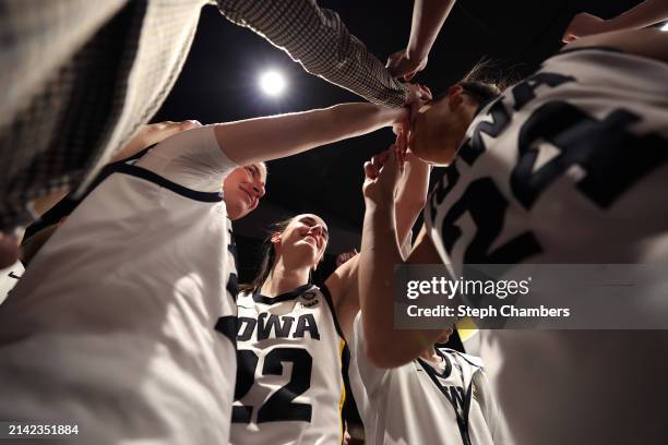 Caitlin Clark of the Iowa Hawkeyes huddles with the team after beating the UConn Huskies in the NCAA Women's Basketball Tournament Final Four...