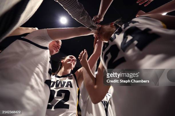 Caitlin Clark of the Iowa Hawkeyes huddles with the team after beating the Connecticut Huskies in the NCAA Women's Basketball Tournament Final Four...