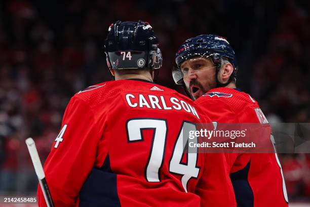 John Carlson of the Washington Capitals celebrates with Alex Ovechkin after scoring a goal against the Carolina Hurricanes during the third period of...