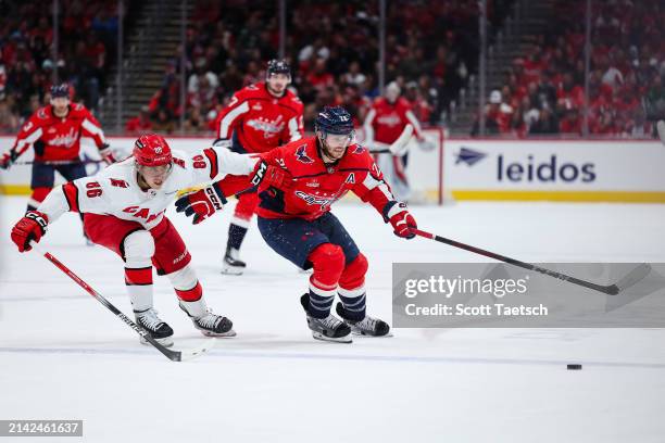 Nic Dowd of the Washington Capitals skates with the puck against Teuvo Teravainen of the Carolina Hurricanes during the second period of the game at...