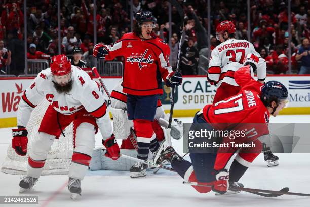 Sonny Milano of the Washington Capitals celebrates with Dylan Strome after scoring a goal against Pyotr Kochetkov of the Carolina Hurricanes during...