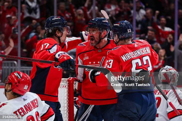 Alex Ovechkin of the Washington Capitals celebrates with Dylan Strome and Ivan Miroshnichenko after scoring a goal against the Carolina Hurricanes...