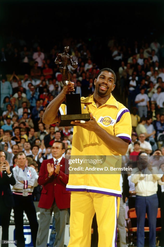 Magic Johnson shows the NBA MVP Trophy