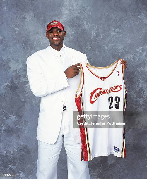 LeBron James of the Cleveland Cavaliers poses with his jersey during the 2003/2004 NBA Draft Portrait at Paramount Theatre Madison Square Garden on...