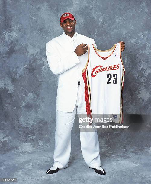 LeBron James of the Cleveland Cavaliers poses with his jersey during the 2003/2004 NBA Draft Portrait at Paramount Theatre Madison Square Garden on...