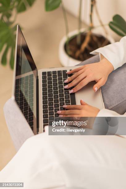 blonde woman in white business suit working at a laptop. style. long hair - draft first round stock pictures, royalty-free photos & images