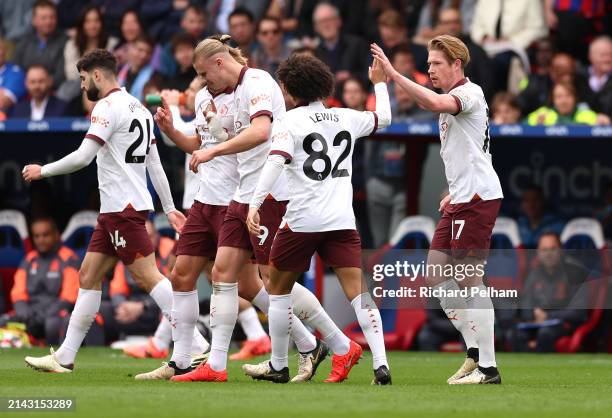 Kevin De Bruyne of Manchester City celebrates scoring his team's first goal with teammate Rico Lewis during the Premier League match between Crystal...