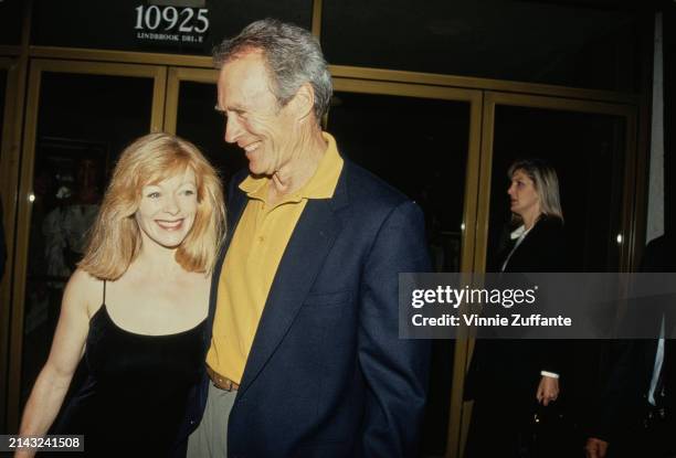 American actress Frances Fisher, wearing a black scoop neck dress, and American actor and film director Clint Eastwood, who wears a dark blue blazer...