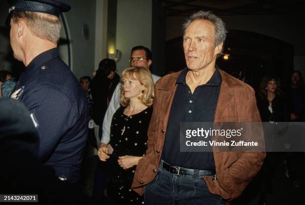 American actress Frances Fisher, wearing a black outfit decorated with gold stars, and American actor and film director Clint Eastwood, who wears a...