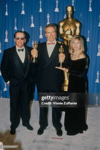 American actor Jack Nicholson, wearing a tuxedo, bow tie and sunglasses, American actor and film director Clint Eastwood, who wears a tuxedo and red...