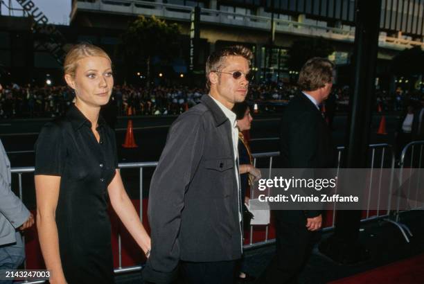 American actress Gwyneth Paltrow, wearing a black short-sleeved outfit, and actor Brad Pitt, who wears a grey jacket over a white shirt, attend the...