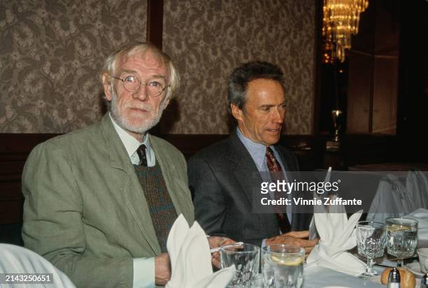 Irish actor Richard Harris, wearing a pale green jacket over a sweater, shirt and tie, and American actor and film director Clint Eastwood, who wears...