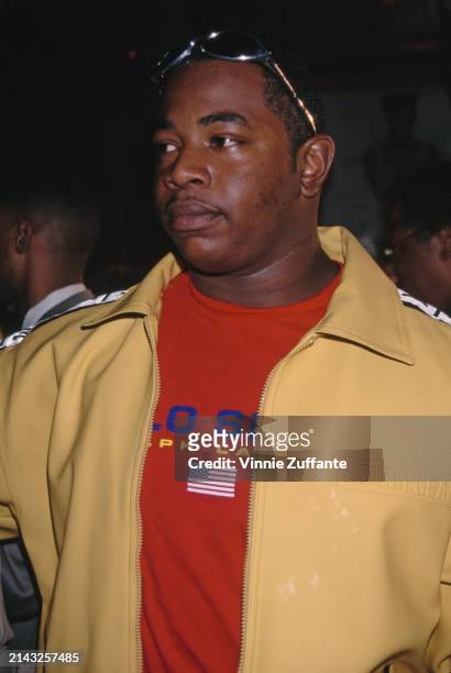 American rapper and record producer Dr Dre, wearing a yellow tracksuit jacket over with a red Ralph Lauren Polo t-shirt, attends the Hollywood...