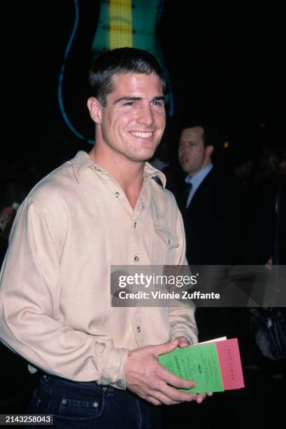 American actor George Eads, wearing a beige shirt with an open collar, attends the Universal City premiere of 'Happy Gilmore', at Cineplex Odeon...