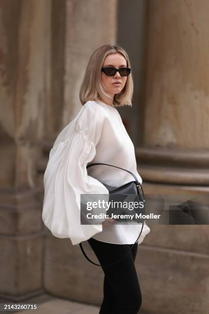 Isabelle Hartmann seen wearing Vehla Eyewear black / brown sunglasses, Khaite oversized puffy ruffled long sleeve silk top, Isabelle Hartmann x...