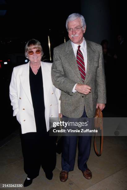 American actor and comedian Dick Van Dyke, wearing a tweed jacket over a white shirt with a diagonally-striped tie, and American actress Michelle...
